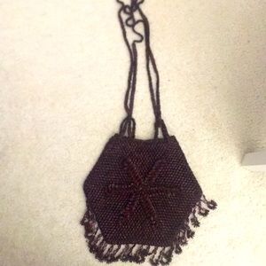2 handmade bags that are exactly the same and are brown and long and beautiful
